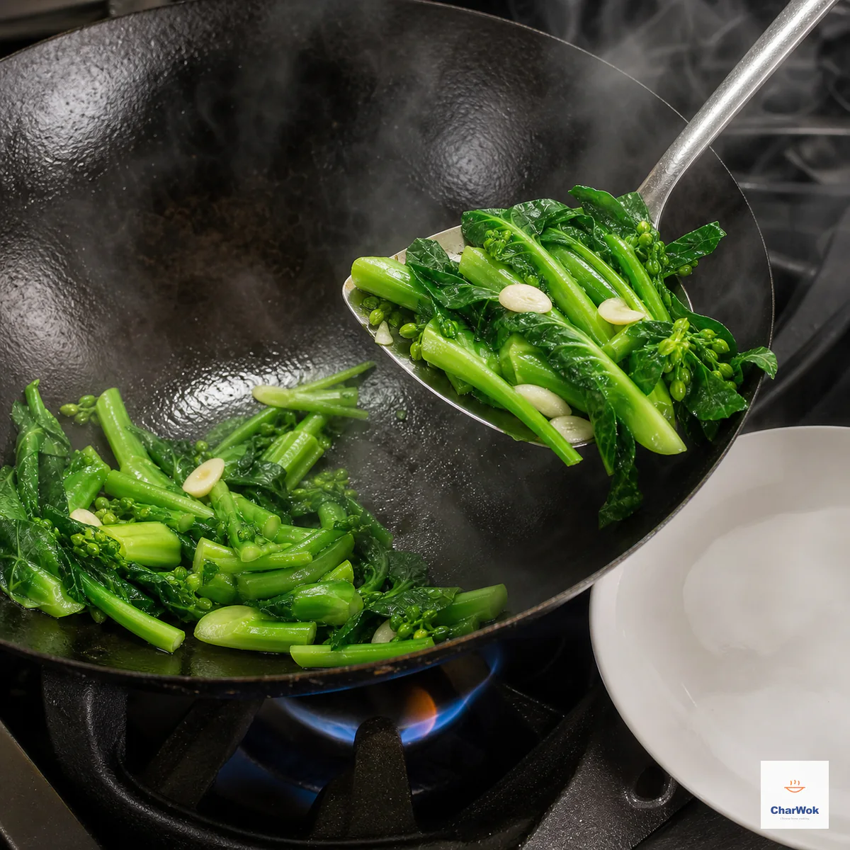 Bright-green Chinese broccoli stems, just-wilted leaves, and sliced garlic are lifted from a hot wok with no pooled water