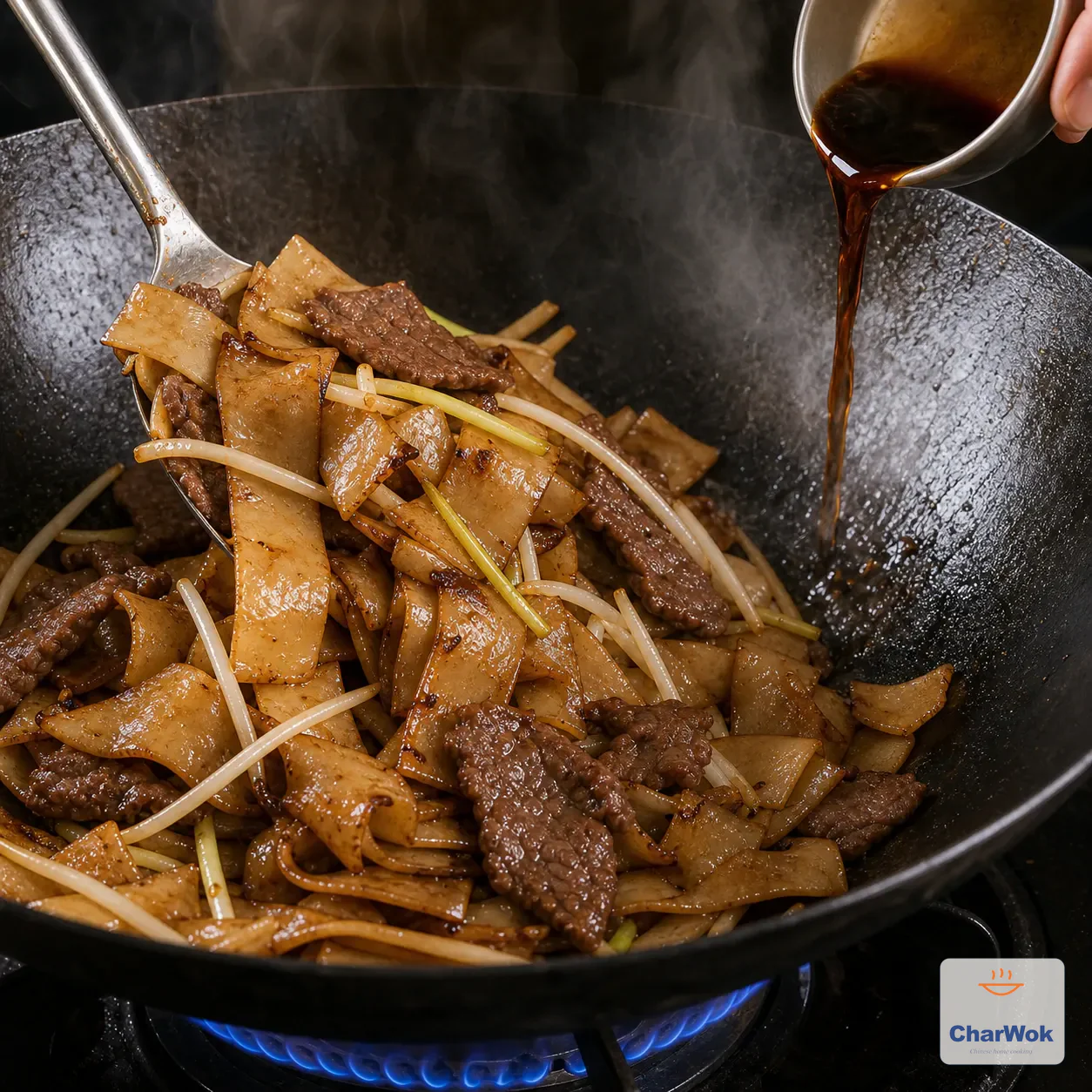 Soy sauce is poured around the hot wok rim as beef, noodles, bean sprouts, onion, and yellow chives are tossed