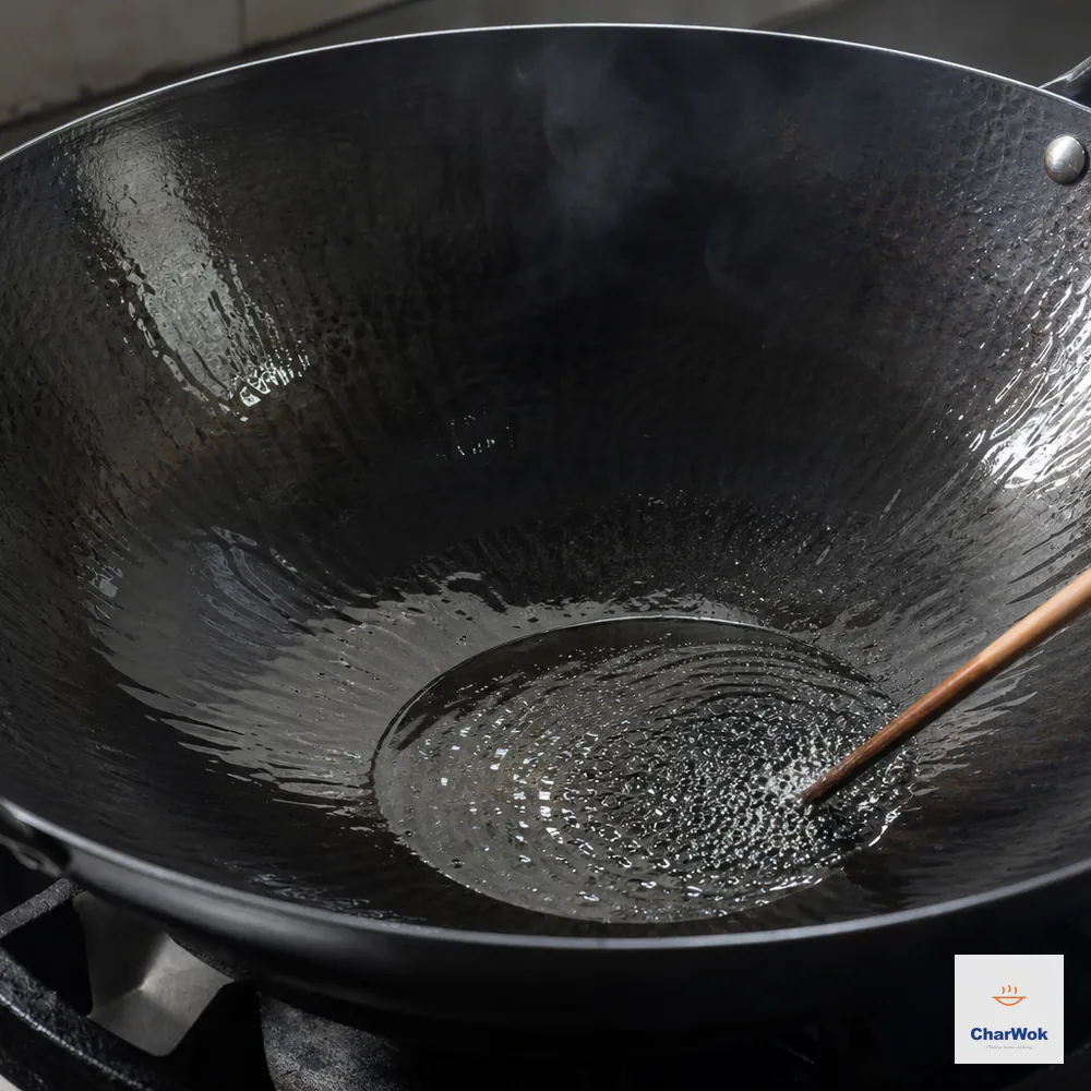 Neutral oil at about 175 to 180°C ripples in a hot carbon-steel wok with no smoke as a chopstick tip makes dense tiny bubbles