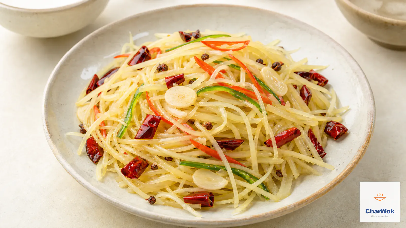 Hot-and-sour Chinese potato stir-fry with crisp separate matchsticks and red and green chilies