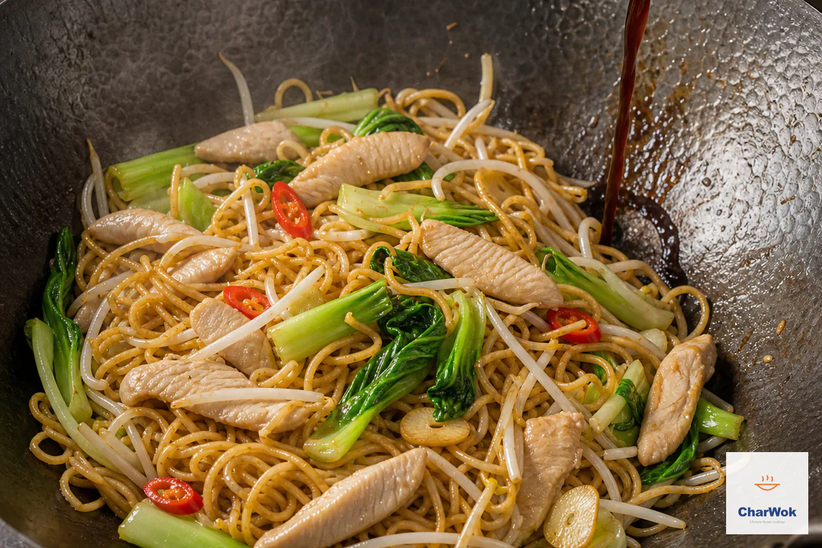 Combined brown sauce runs down the hot wok wall onto chow mein noodles, returned chicken, baby bok choy and crisp bean sprouts with no sauce pool below