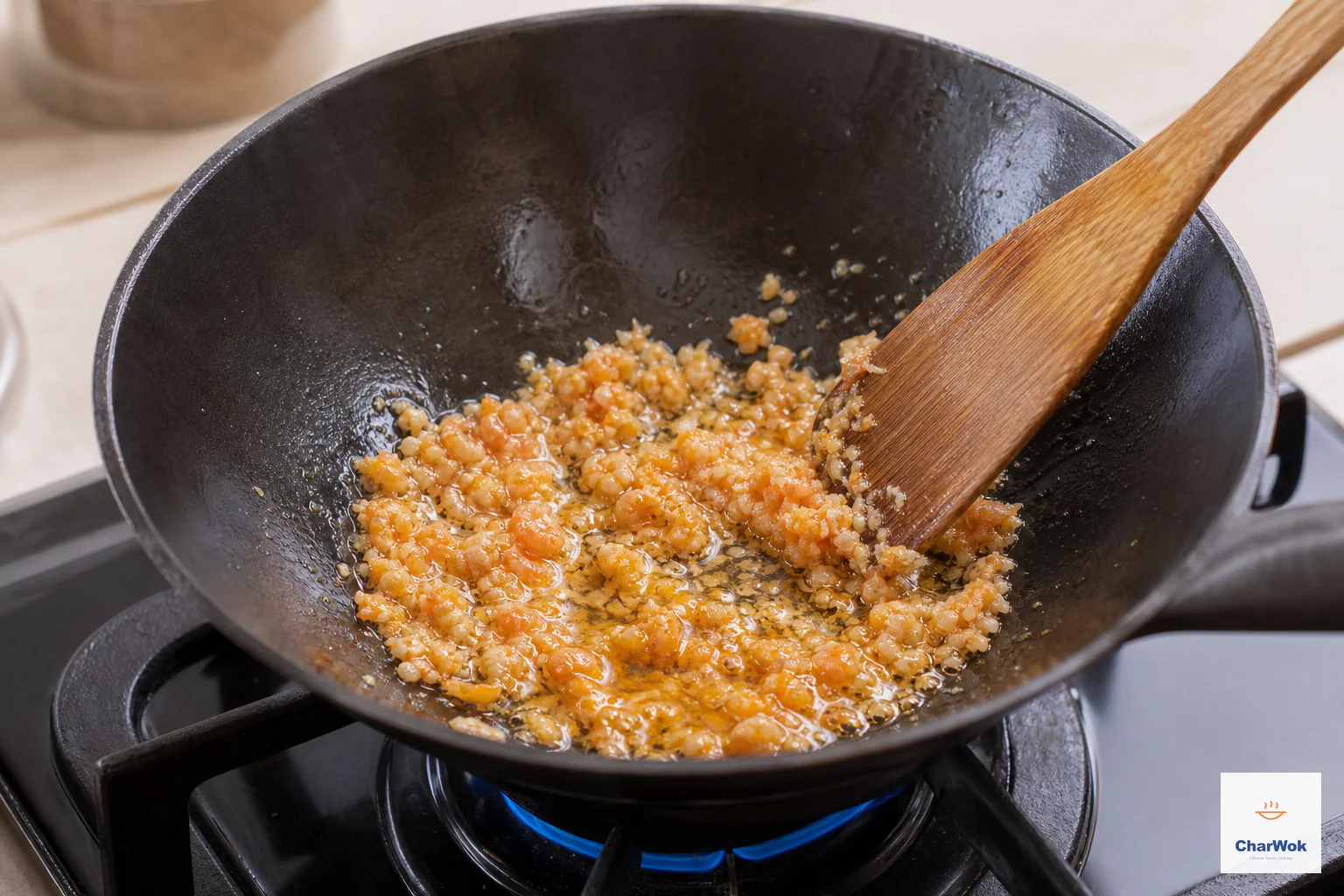 Finely minced dried shrimp briefly sizzle in a shallow tablespoon of faintly orange oil over a modest blue flame