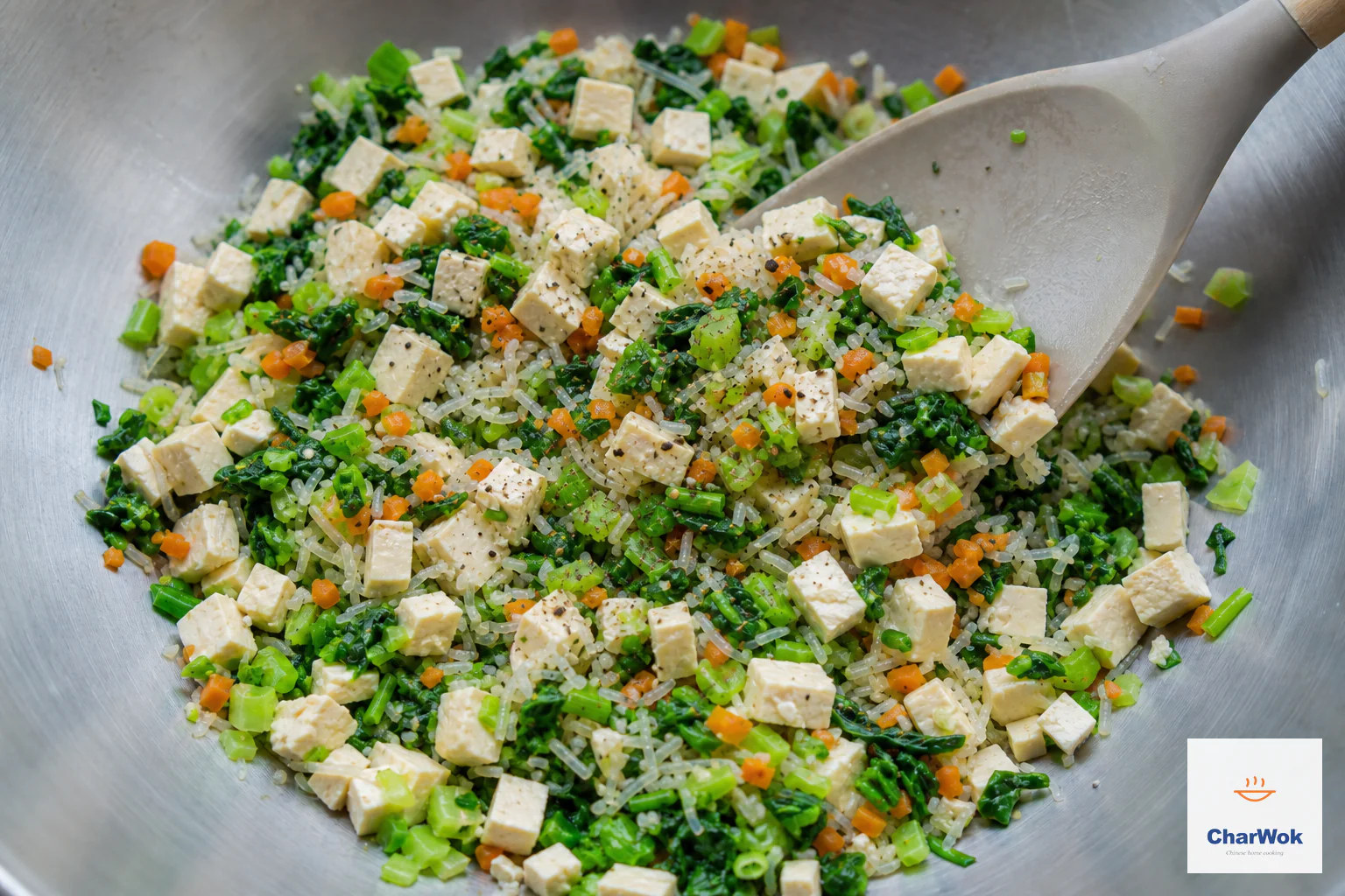 Neat tofu dice, squeezed bok choy, carrot, scallion and short pieces of mung-bean vermicelli are gently folded into a dry vegan filling