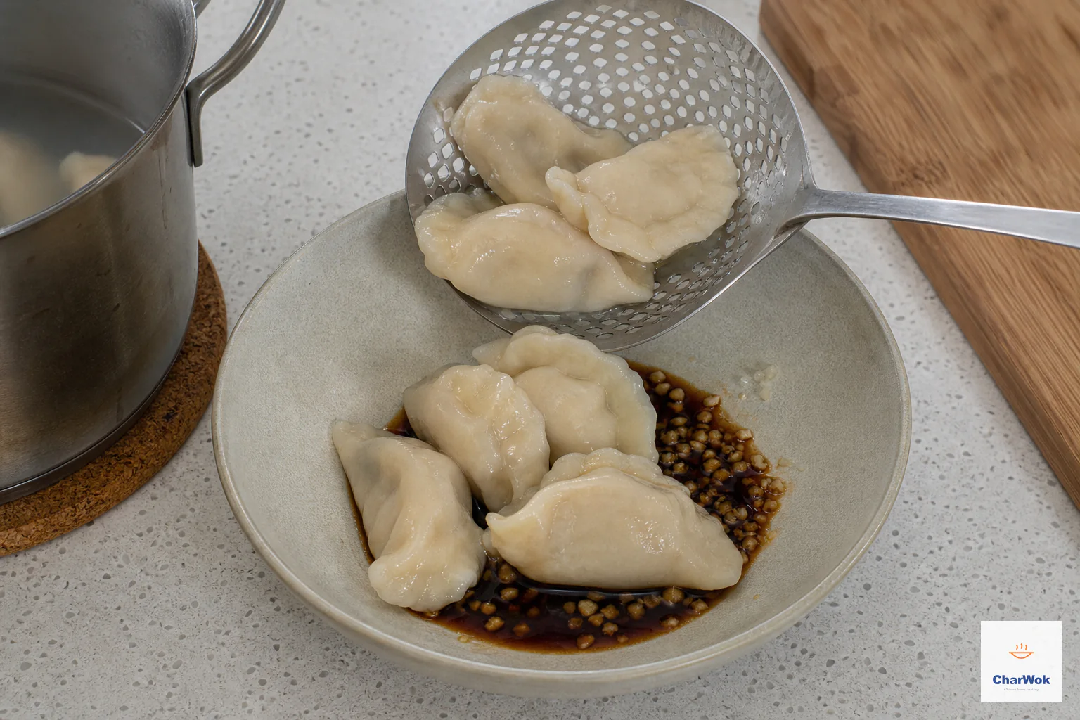 Freshly boiled pale dumplings are transferred into dark glossy Sichuan sweet soy and minced garlic before chili oil is added