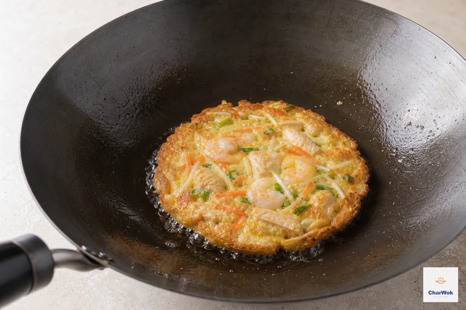 One egg foo young patty fries with a deep-golden crisp edge and a moist softly set top showing shrimp, chicken and vegetables