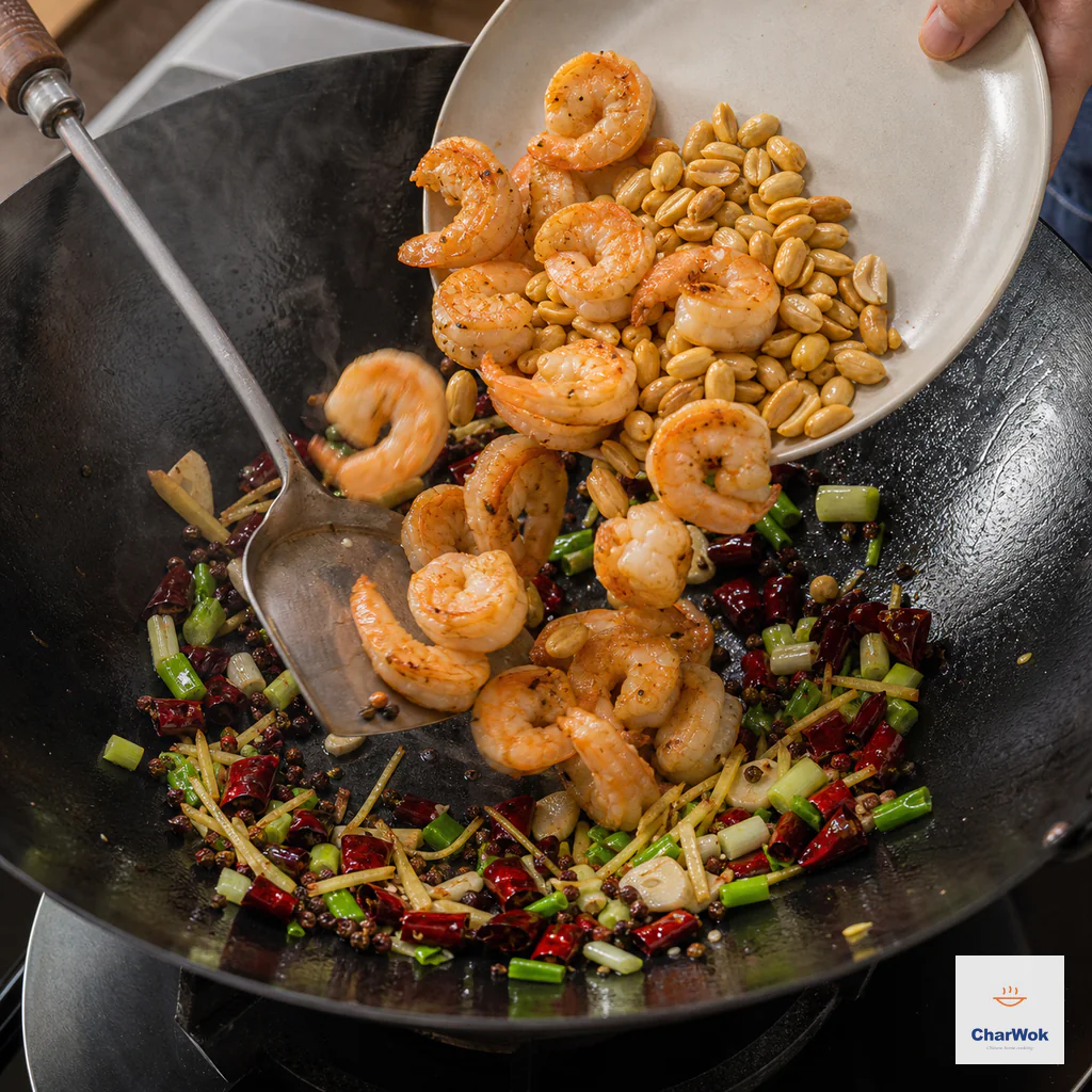 Partly cooked shrimp and toasted peanuts are tipped back into the dry aromatic wok with bright scallion pieces