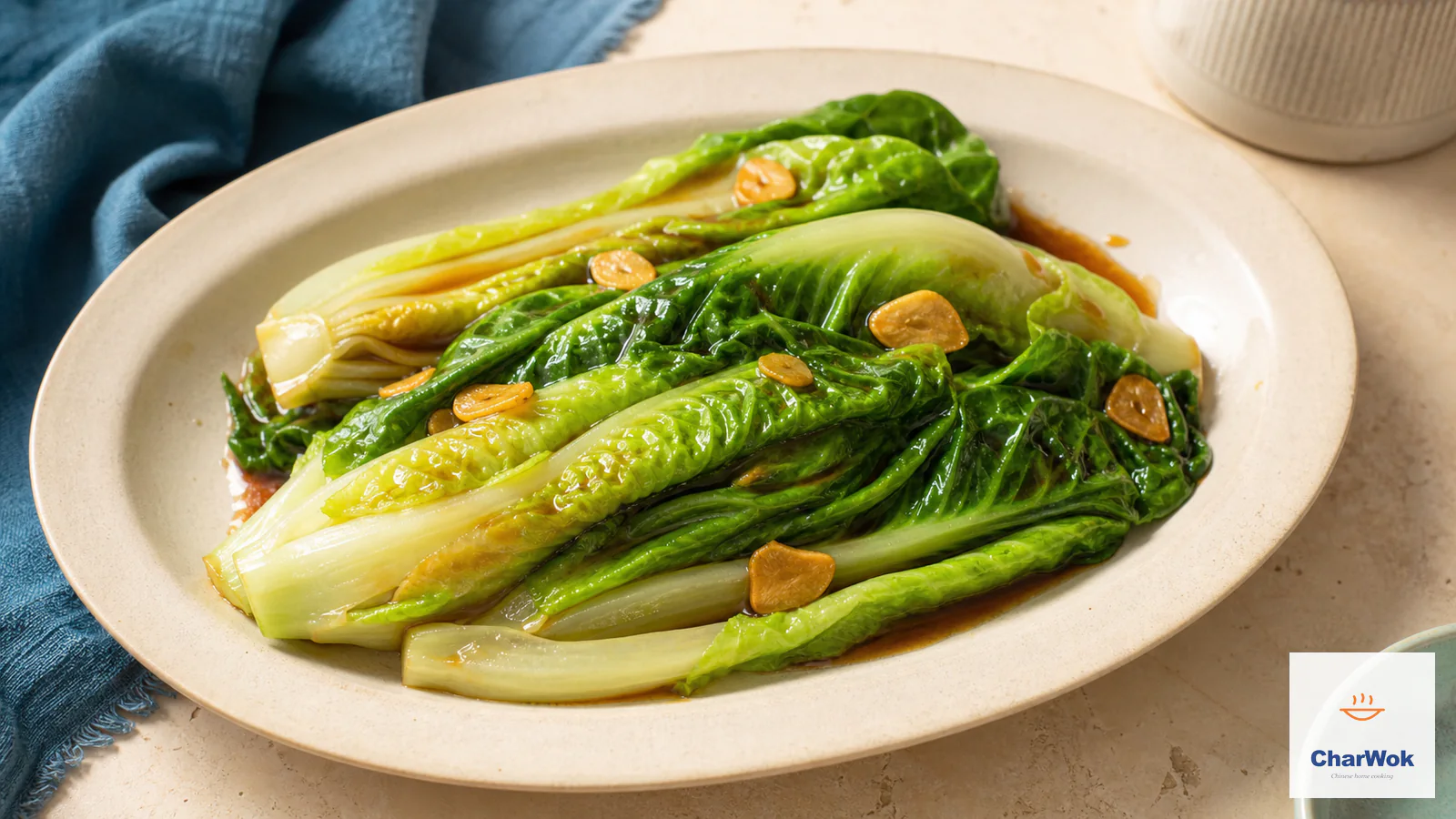 Bright-green blanched little-gem lettuce with crisp pale ribs, glossy brown oyster sauce, and thin pale-gold garlic slices on an ivory oval plate