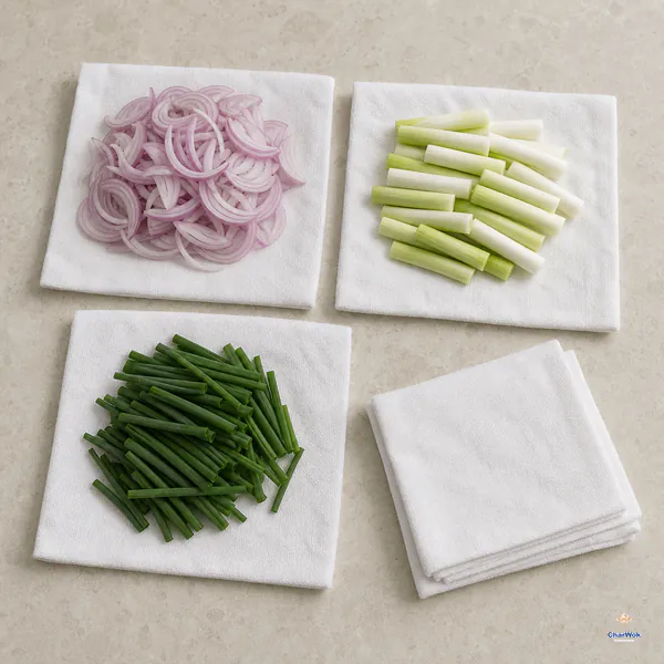 Thin shallot slices, dry scallion white segments and dry dark-green scallion tops sit in three separate piles on plain white towels