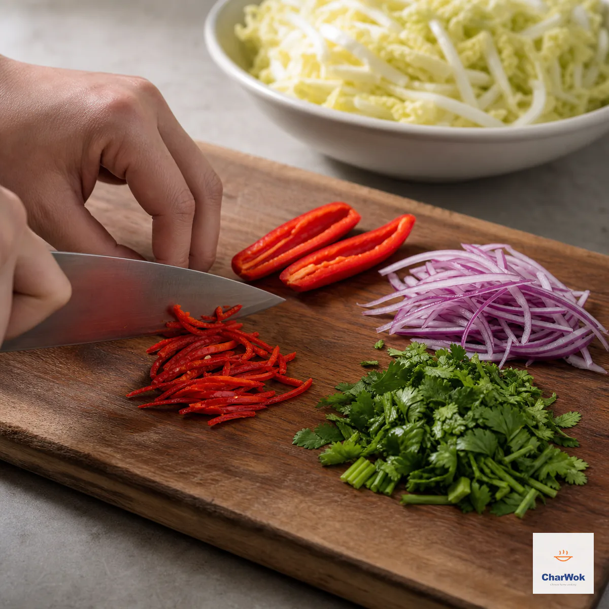 Seeded red chili halves, fine chili strips, fine red onion strips, and chopped cilantro stems and leaves are cut to match the cabbage width