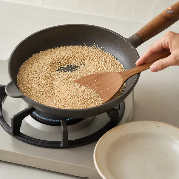 White sesame seeds are kept moving in a dry skillet over low heat until they turn a half-shade darker without scorching