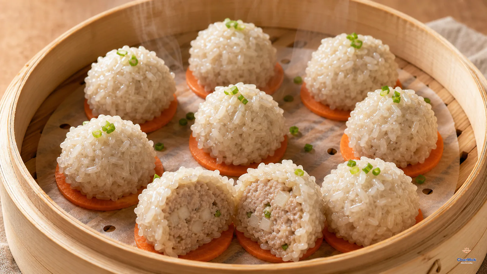 Nine steamed pearl meatballs coated in glossy translucent glutinous rice, each on a carrot slice, with one cut open to show cooked pork, water chestnut and scallion
