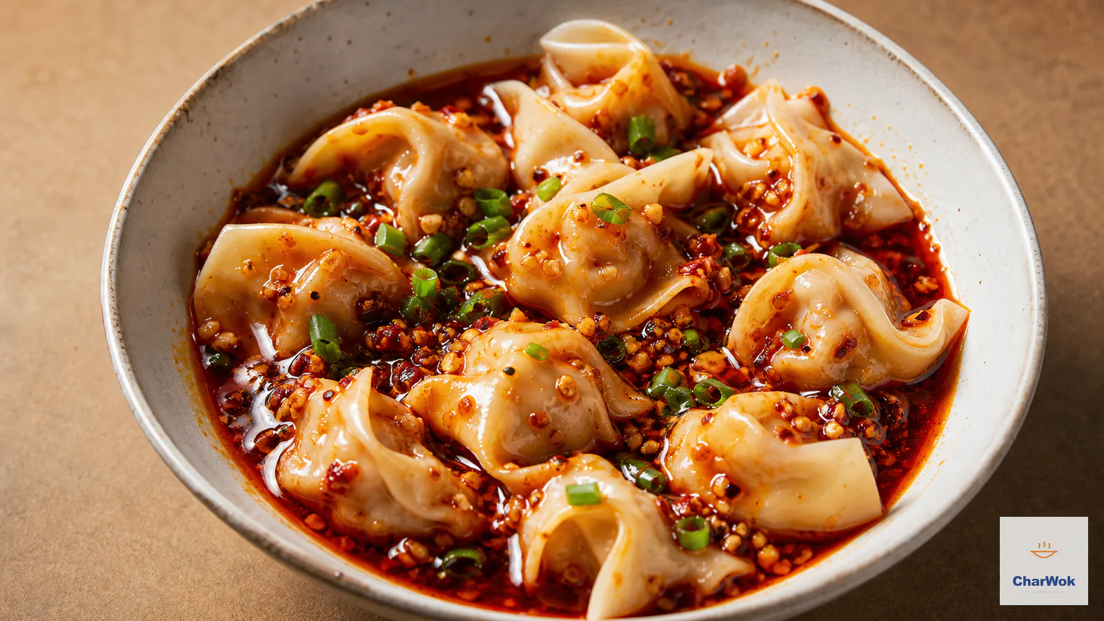 Sichuan wontons in vivid red chilli oil with slippery thin wrappers, scallion and ground Sichuan pepper