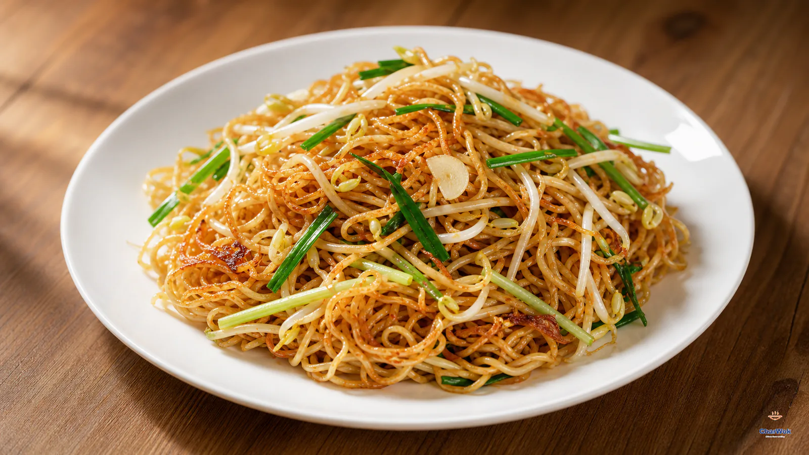 Glossy soy sauce pan-fried thin egg noodles with crisp golden edges, crunchy bean sprouts and green scallion slivers