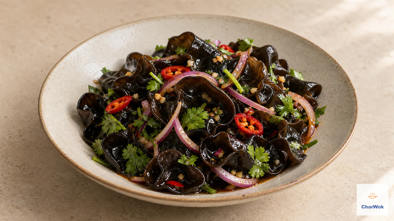 Glossy chilled wood ear mushroom salad with red onion, sliced red chilli, cilantro and a tangy garlic dressing